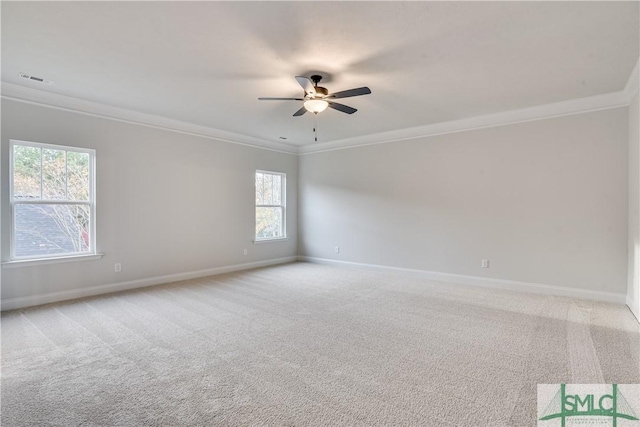 unfurnished room featuring a ceiling fan, light colored carpet, crown molding, and baseboards