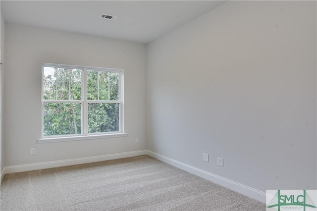 empty room featuring carpet flooring and baseboards