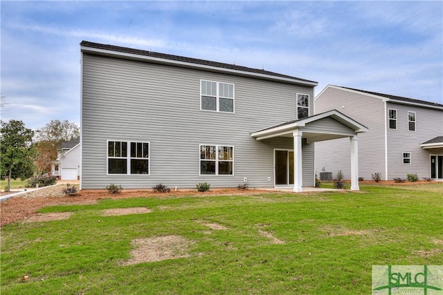 rear view of house featuring a patio area and a lawn