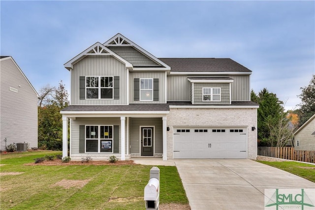 craftsman-style house with a garage, central AC, concrete driveway, board and batten siding, and a front yard