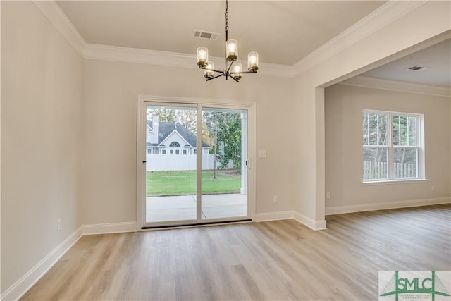 doorway to outside with a wealth of natural light, visible vents, and crown molding