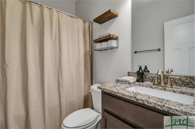 bathroom featuring toilet and vanity