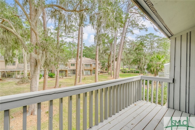 deck featuring a residential view and a lawn