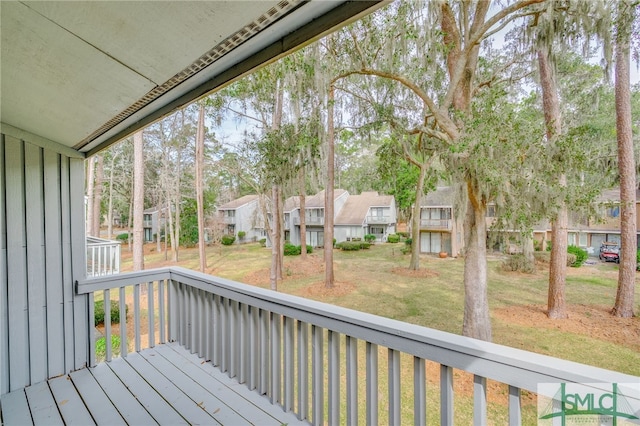 wooden deck with a residential view and a lawn