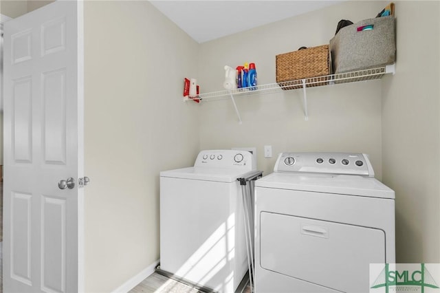 washroom with laundry area and washer and dryer