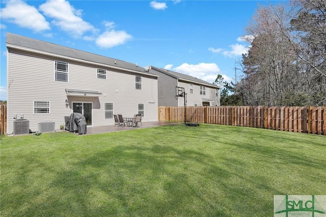 rear view of property featuring a lawn, a patio area, fence, and central air condition unit