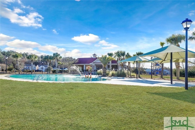 pool with a lawn and a patio