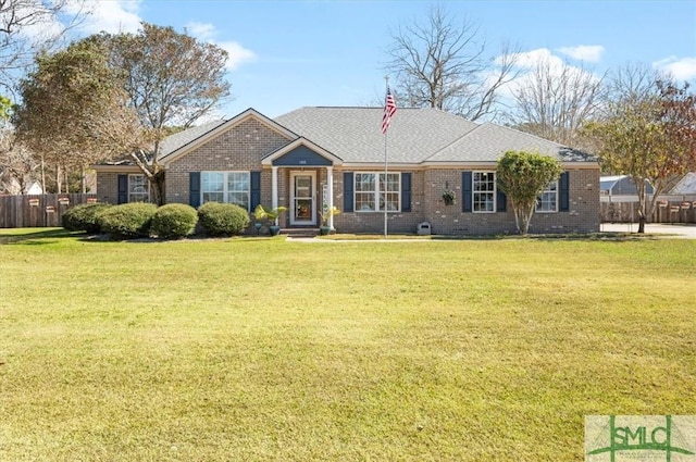 ranch-style house featuring brick siding, roof with shingles, fence, and a front yard