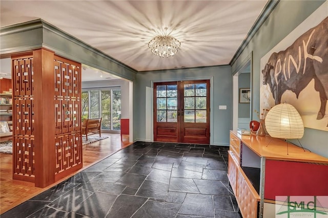 doorway with stone tile flooring, french doors, crown molding, and baseboards