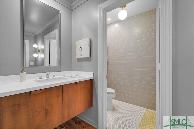 bathroom with ornamental molding, vanity, toilet, and tile patterned floors