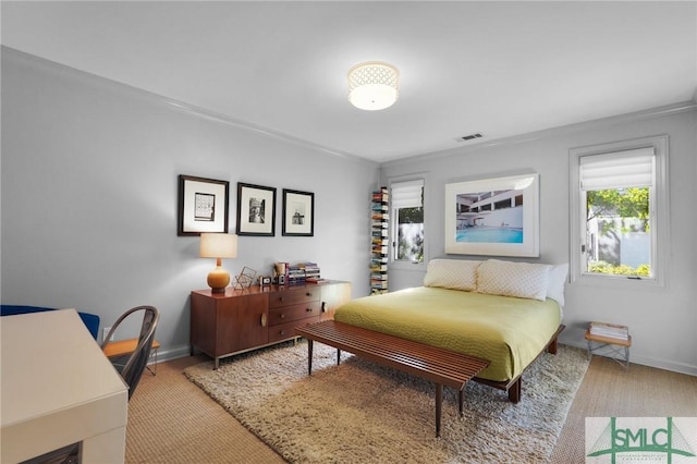 bedroom featuring carpet floors, visible vents, and baseboards