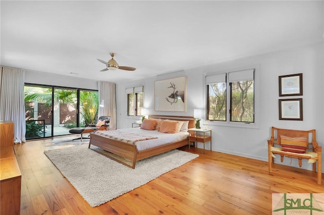 bedroom featuring a ceiling fan, access to outside, baseboards, and hardwood / wood-style floors