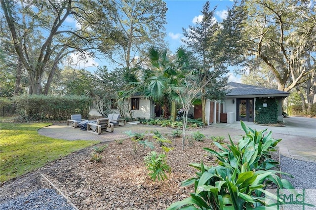 view of front of house with a patio and a front lawn