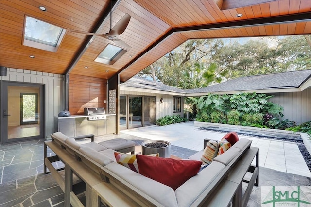 view of patio / terrace featuring an outdoor living space, exterior kitchen, and area for grilling