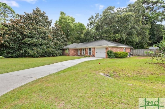 single story home with a front lawn, fence, driveway, and an attached garage