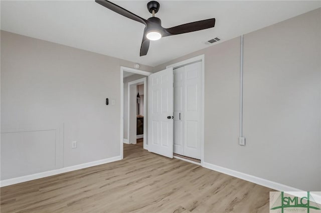 unfurnished bedroom featuring baseboards, visible vents, and light wood-style floors