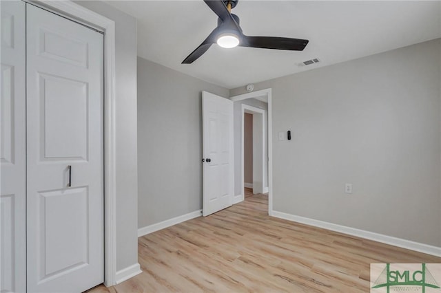 unfurnished bedroom featuring ceiling fan, light wood-type flooring, visible vents, and baseboards