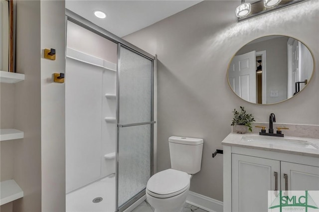 bathroom featuring baseboards, toilet, vanity, a shower stall, and recessed lighting