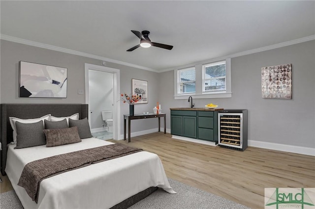 bedroom with light wood-type flooring, wine cooler, and crown molding