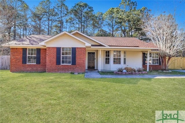 single story home with fence, a front lawn, and brick siding