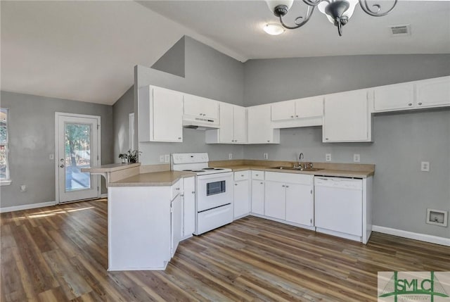 kitchen with visible vents, a sink, white appliances, a peninsula, and under cabinet range hood