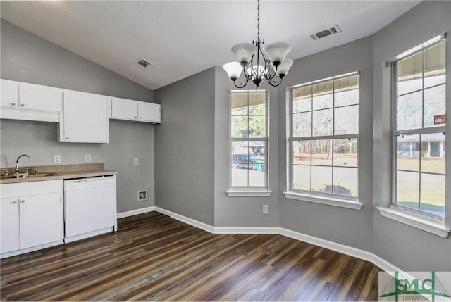 kitchen with visible vents, dark wood-style floors, white dishwasher, vaulted ceiling, and a sink