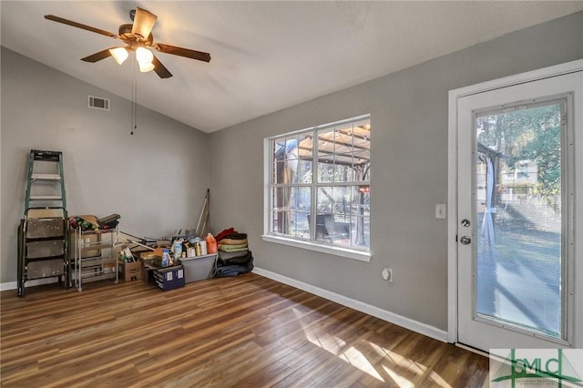 miscellaneous room featuring ceiling fan, wood finished floors, visible vents, baseboards, and vaulted ceiling