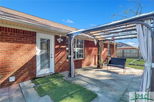 view of patio with fence and a pergola