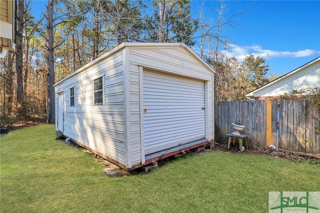 view of outbuilding with fence and an outdoor structure