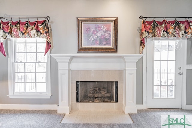 room details with carpet floors, baseboards, and a tiled fireplace