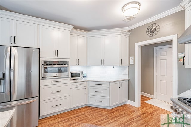 kitchen with a toaster, visible vents, white cabinets, light wood-style flooring, and stainless steel appliances