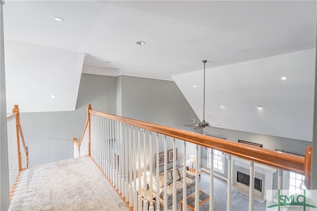 hall featuring crown molding, lofted ceiling, recessed lighting, carpet flooring, and an upstairs landing