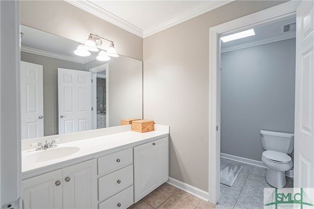 bathroom with ornamental molding, toilet, vanity, and baseboards