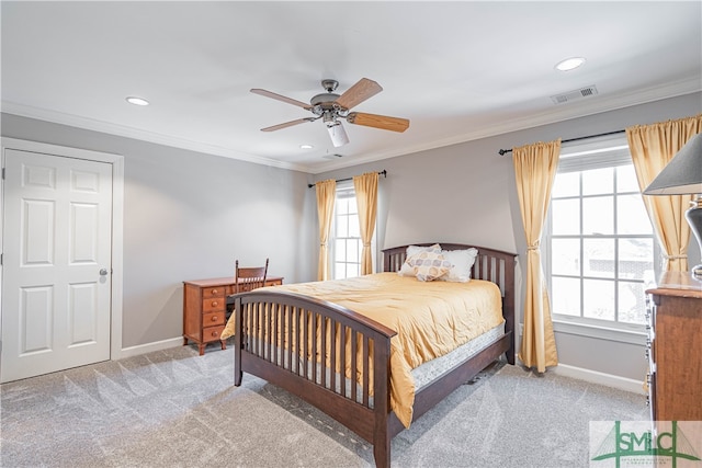 bedroom with crown molding, baseboards, visible vents, and light colored carpet