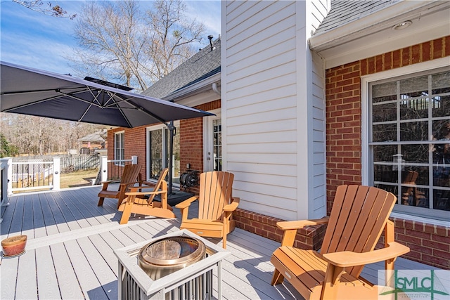 wooden terrace with an outdoor fire pit