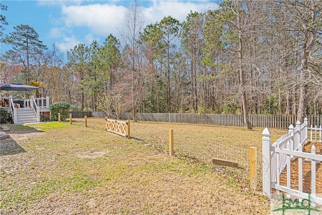 view of yard featuring a fenced backyard and a wooden deck