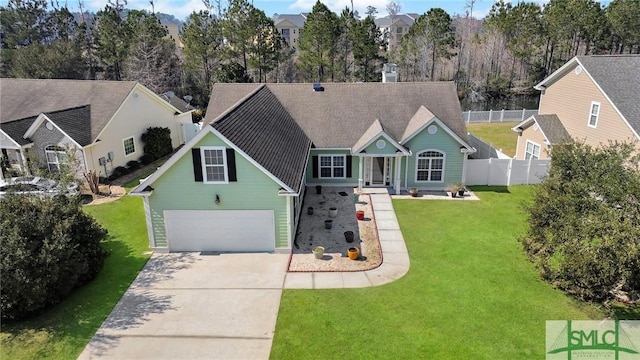 view of front of home featuring roof with shingles, fence, concrete driveway, and a front yard