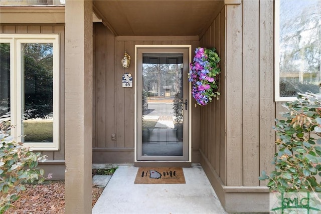 view of exterior entry featuring board and batten siding