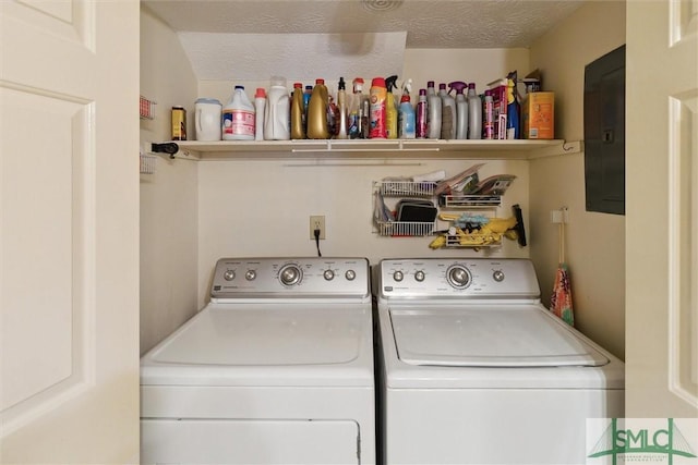 laundry area featuring laundry area, washer and clothes dryer, and a textured ceiling