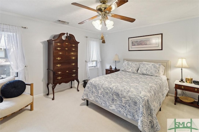 bedroom with ceiling fan, light colored carpet, visible vents, baseboards, and crown molding