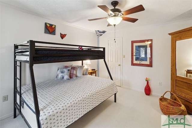 bedroom featuring carpet, baseboards, a ceiling fan, and ornamental molding