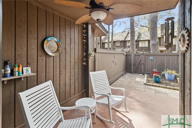 view of patio / terrace featuring ceiling fan and fence