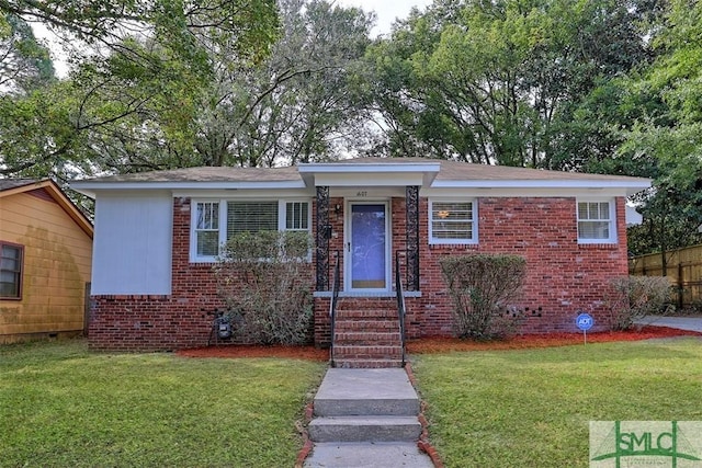 view of front of property with crawl space, a front lawn, and brick siding