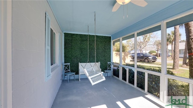 unfurnished sunroom with ceiling fan