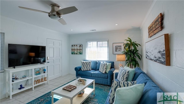 living room featuring ceiling fan, recessed lighting, light tile patterned flooring, and crown molding