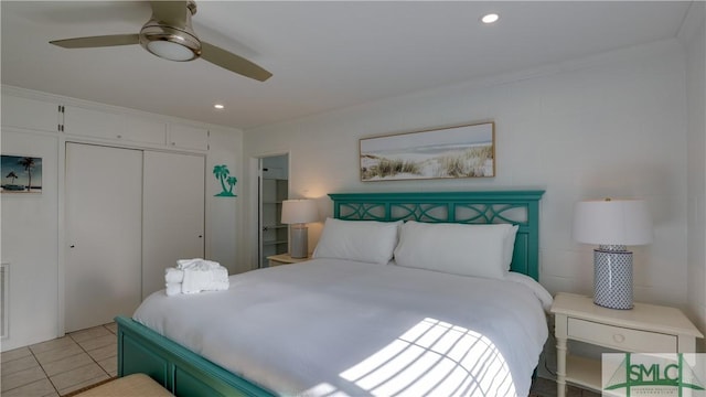 bedroom with ceiling fan, a closet, light tile patterned flooring, and recessed lighting