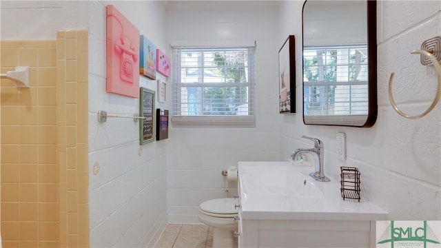 bathroom featuring tile patterned flooring, vanity, and toilet