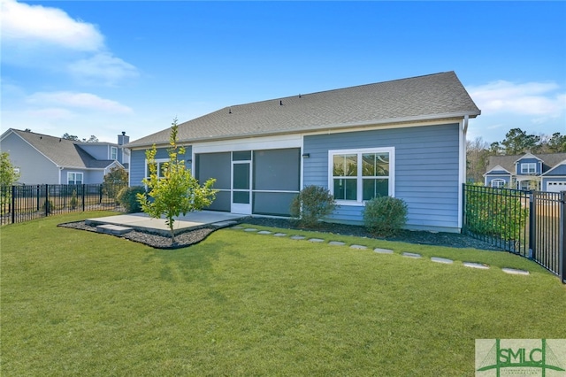 rear view of property featuring a patio, a lawn, and a fenced backyard