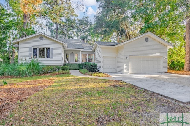 ranch-style home featuring concrete driveway, an attached garage, and a front yard