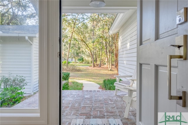 doorway featuring brick floor